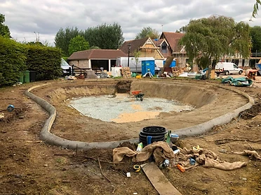 Concrete pool shell with drainage channel cast into the surround, Surrey