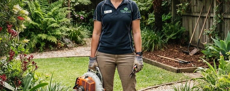 Professional gardener with tools in a tidy garden