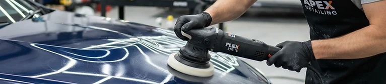 Car detailer polishing a glossy car bonnet