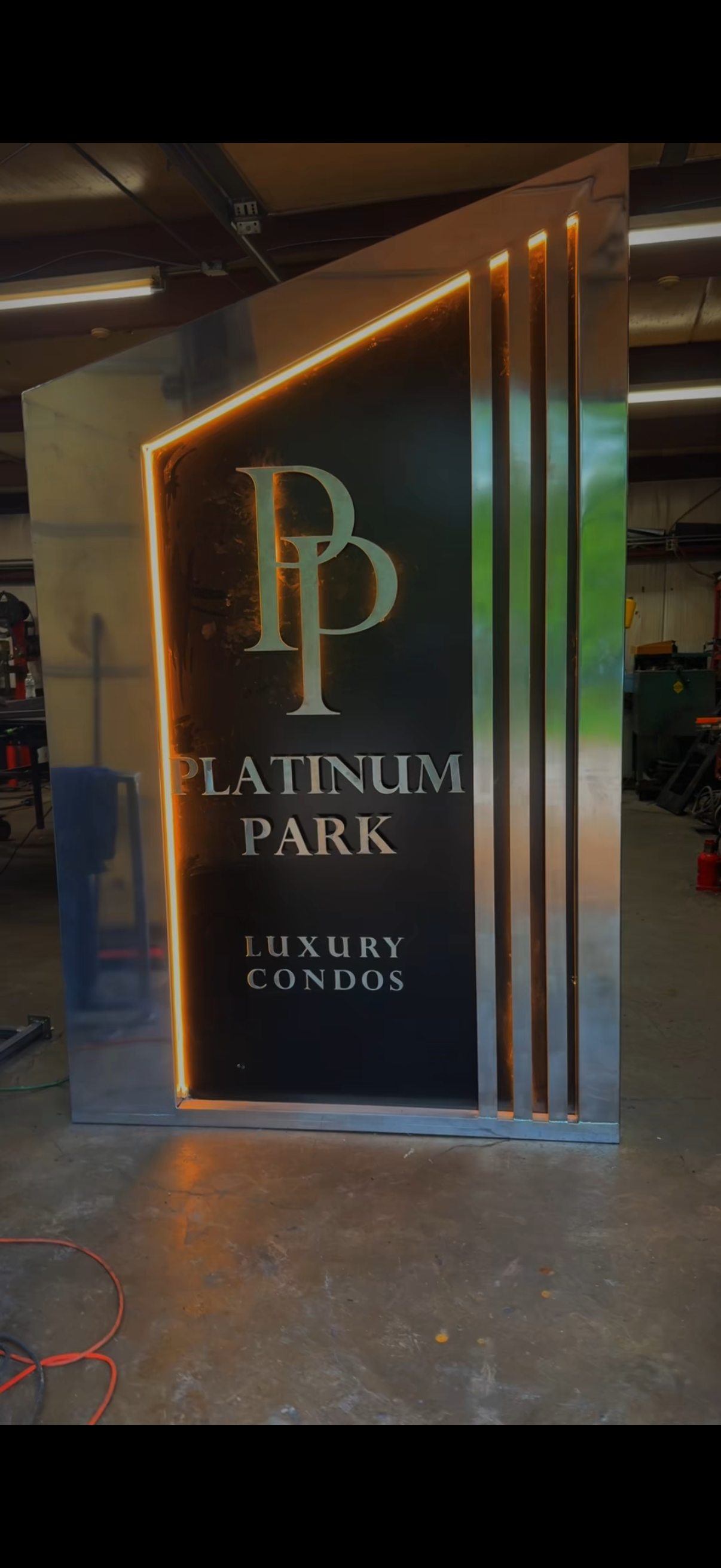 Platinum Park Luxury Condos illuminated stainless steel monument sign in the shop