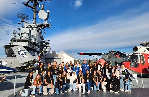 Students on the flight deck of a naval ship