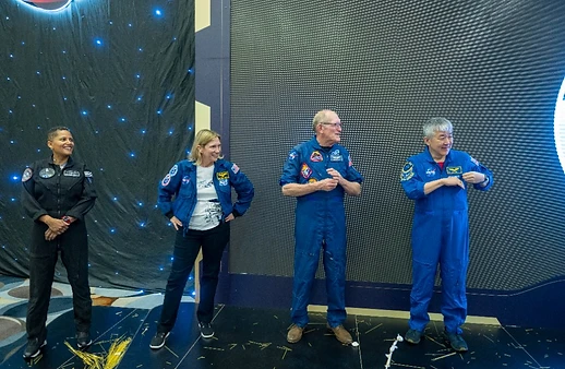Program team on stage with starry backdrop