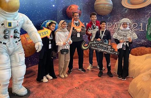 Students with giant astronaut figure at KAUST