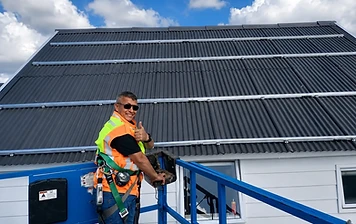 Technician completing a rooftop solar install.