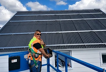 Technician on a scissor lift completing a rooftop install.