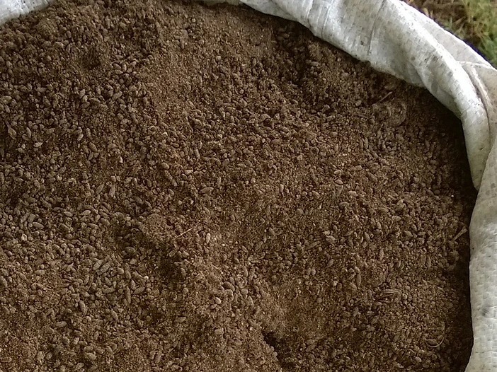 Woven bag filled with granular bat guano fertilizer