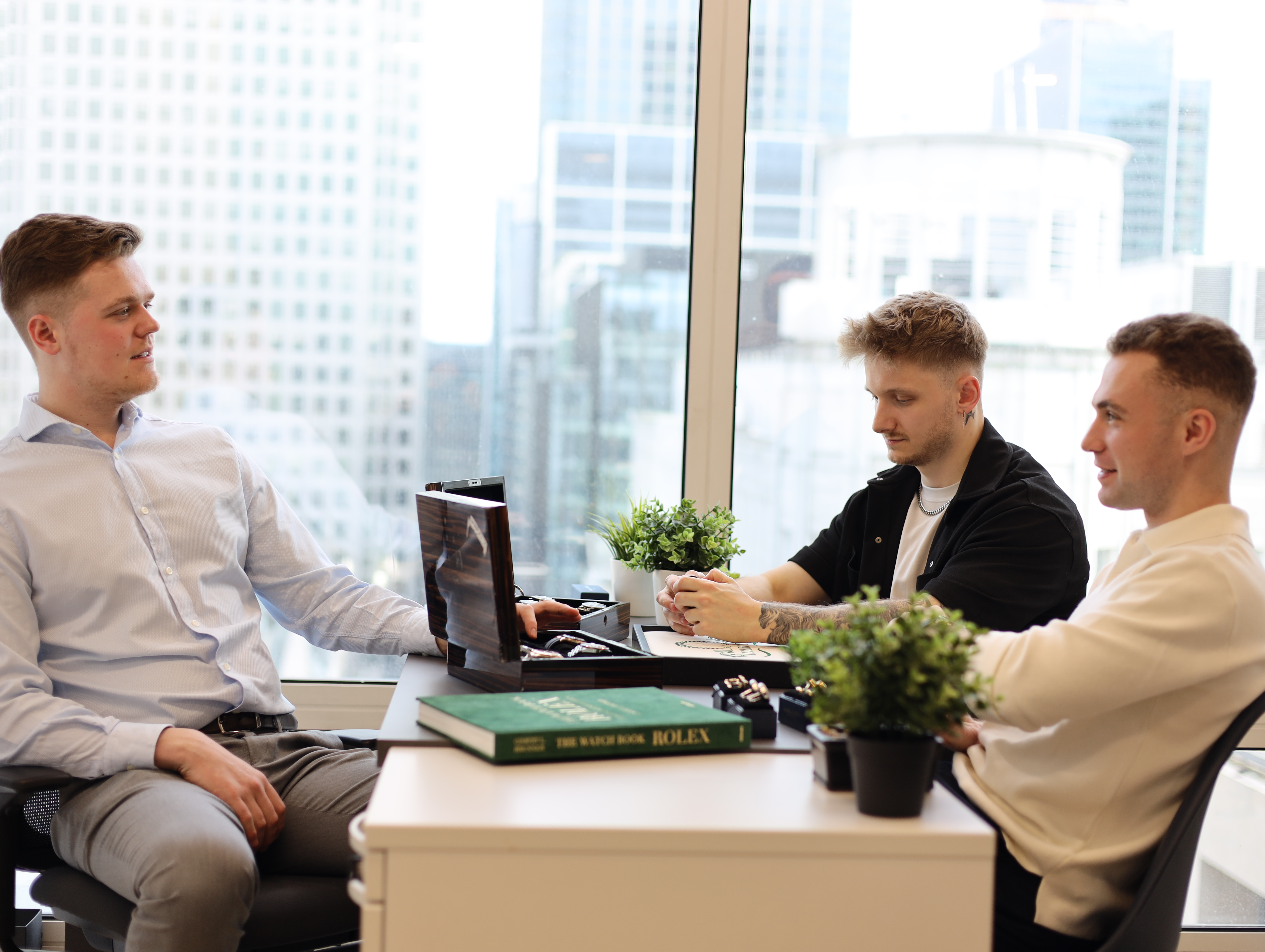 Luxury Times team in conversation over a watch box