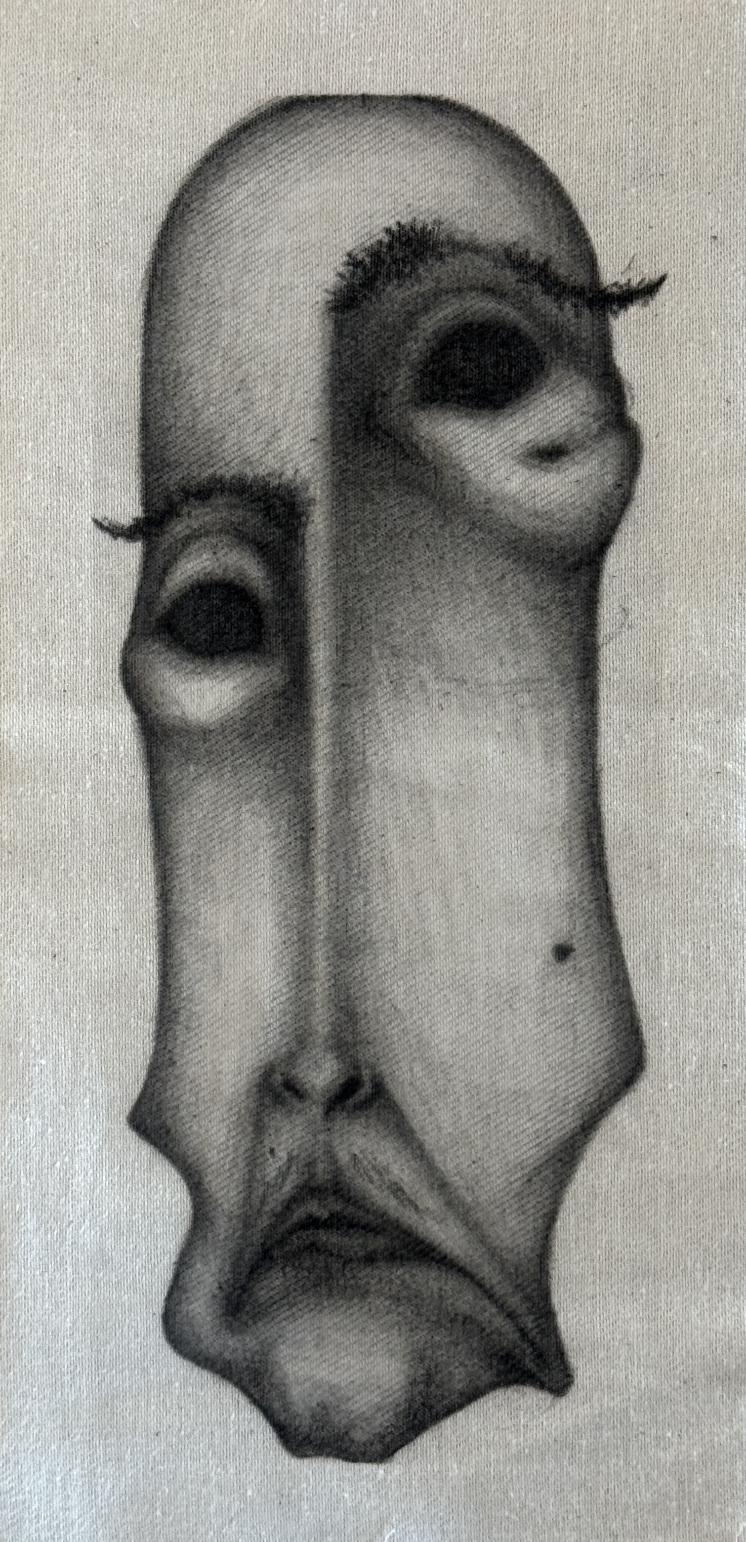 Charcoal drawing of an elongated face on canvas