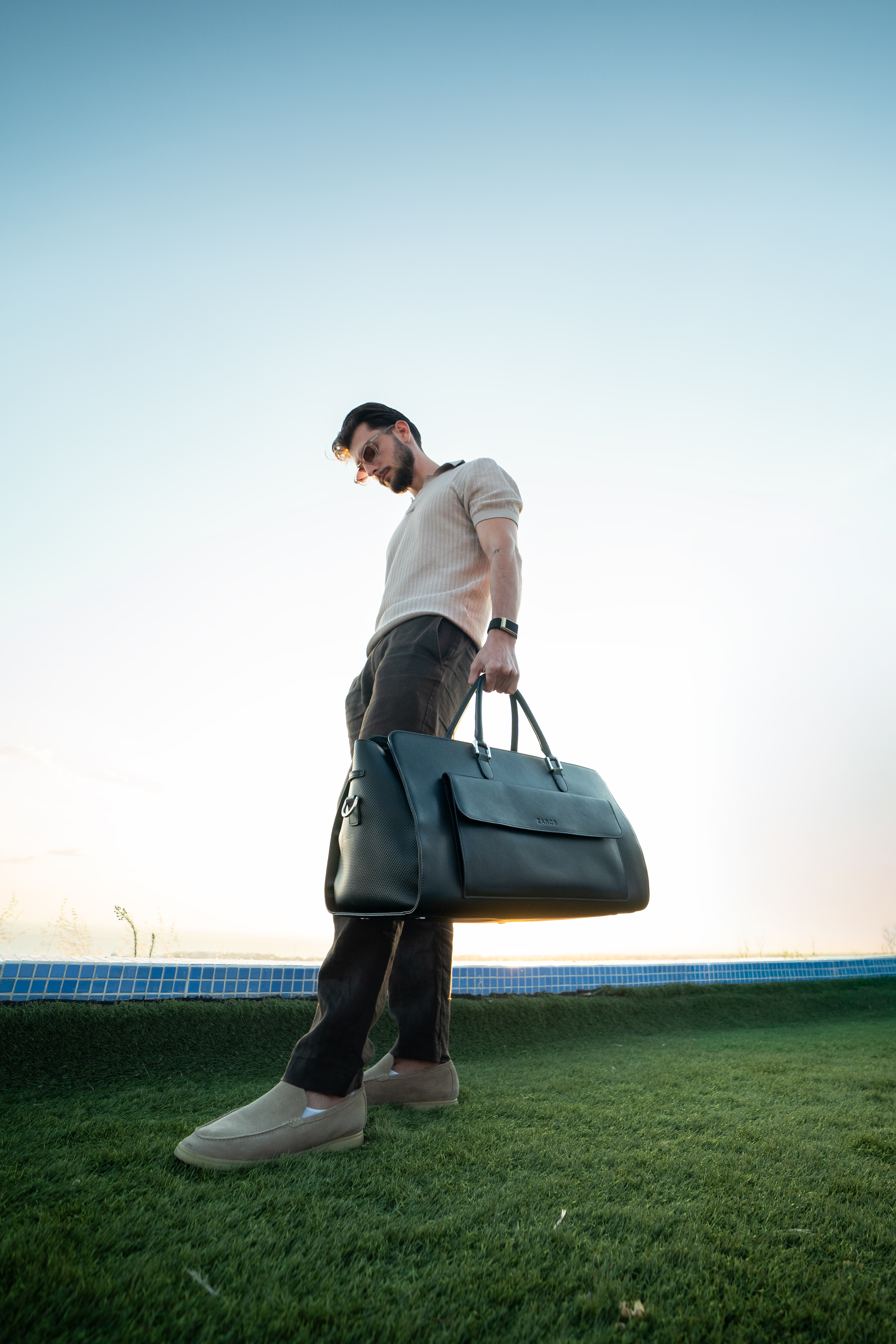 Low-angle shot of a man carrying a ZAROS holdall