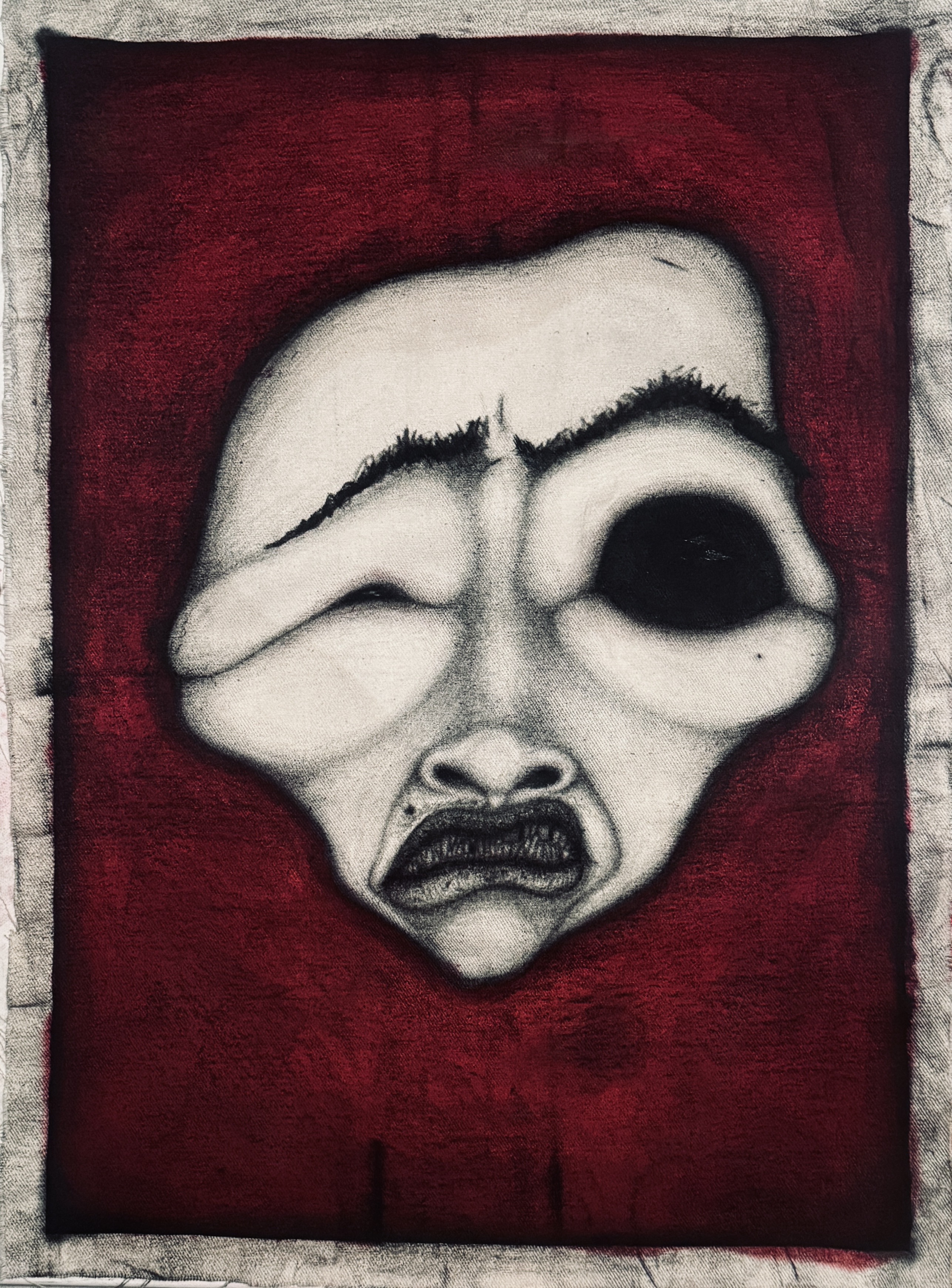 Distorted charcoal face on a deep red canvas