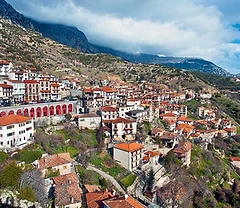 Arachova village built into the slopes of Mount Parnassos with terracotta roofs and mountain backdrop