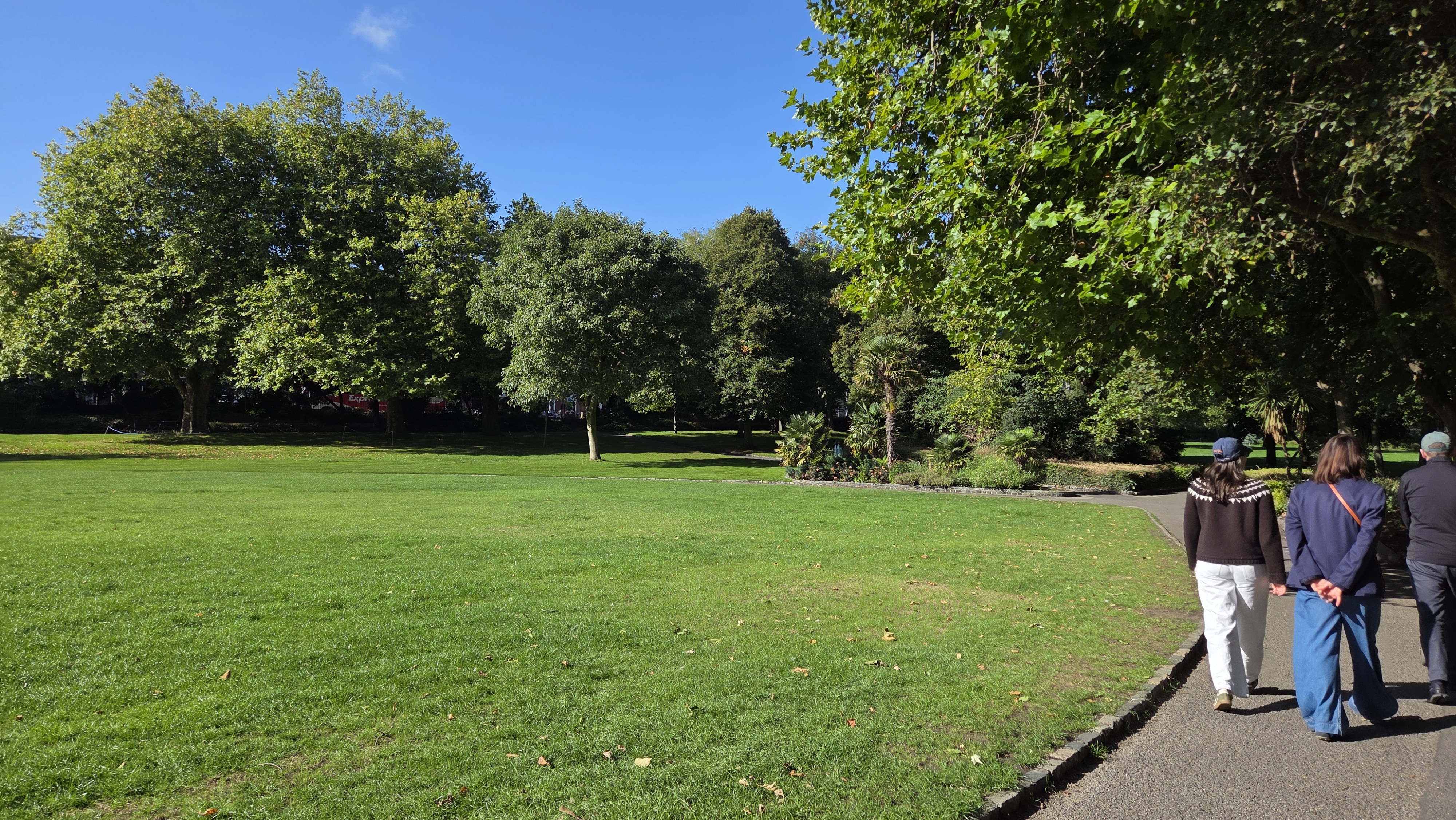 Packed-earth path crossing the worn lawn
