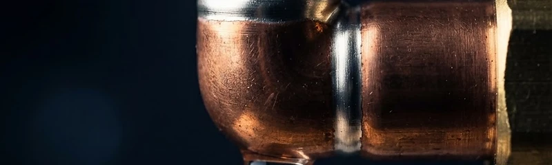 Macro close-up of a perfectly soldered copper pipe joint