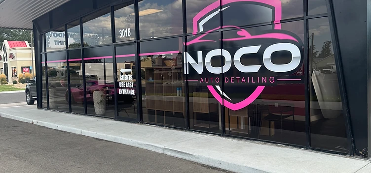 Commercial storefront glass being professionally cleaned near Evans, Colorado