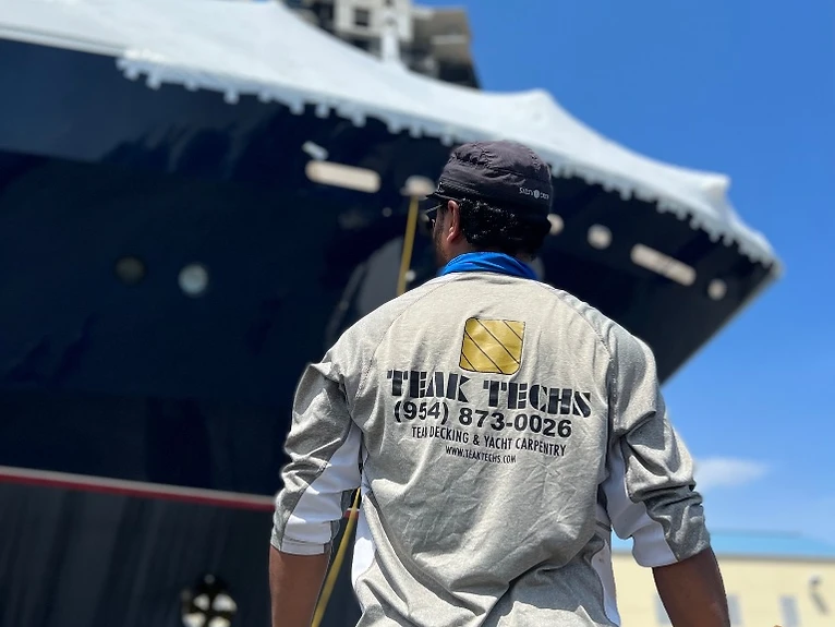 Teak Techs technician applying teak deck caulking on a Fort Lauderdale yacht