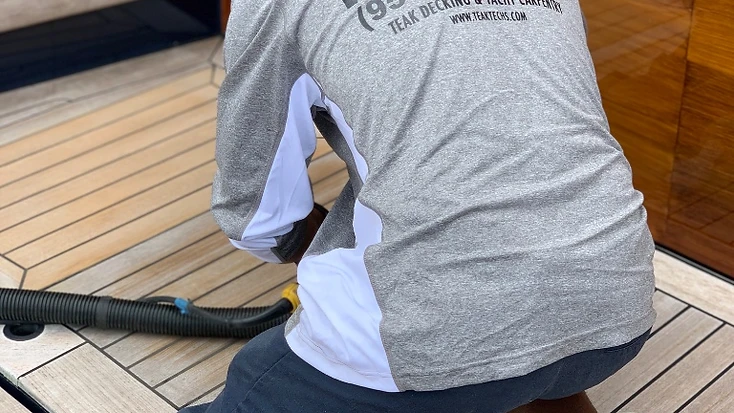 Teak Techs sanding the yacht Vantage's teak deck before the Miami Boat Show