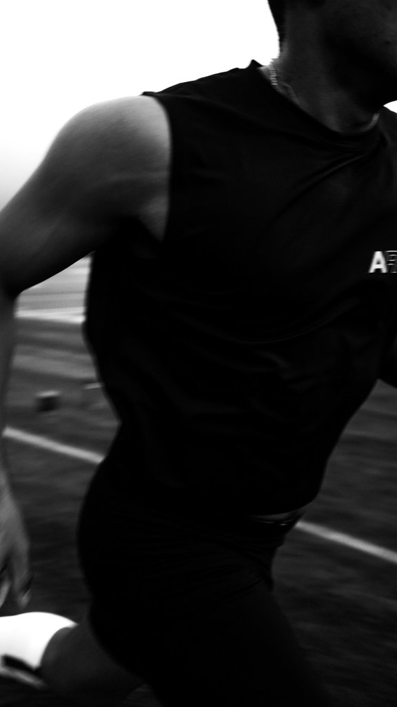 Athlete mid-sprint in AION training gear