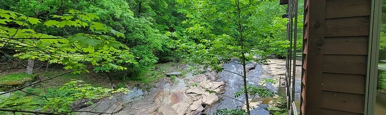 A healing creek flowing over stone ledges beside the campus