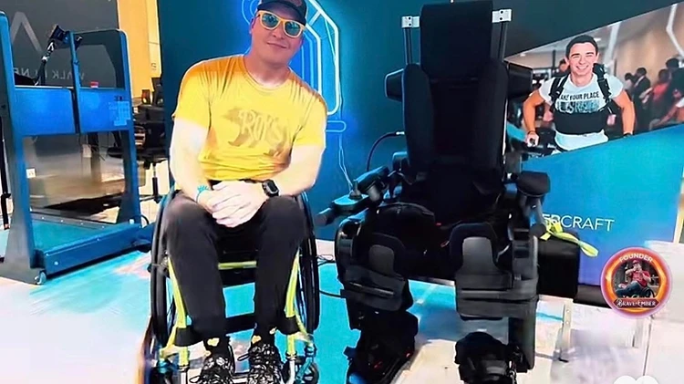 Joshua L. Holm with the Wandercraft exoskeleton — the technology this campaign funds