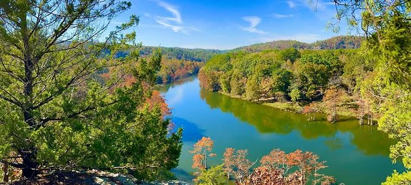 Broken Bow Lake with crystal clear emerald water surrounded by pine forest