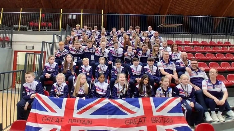 Great Britain Jujitsu squad with the Great Britain flag at an international event