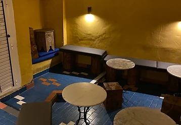 Seating area with ochre walls and tiled floor