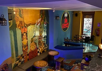 Interior of Fata Morgana with the mural and neon