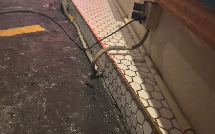 Professional hexagon mosaic tile layout at a commercial storefront entrance in Pinellas County