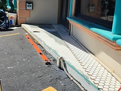White hexagon mosaic tile being installed at a commercial storefront in Largo, Florida