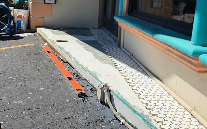 White hexagon mosaic tile being installed at a commercial storefront in Largo, Florida