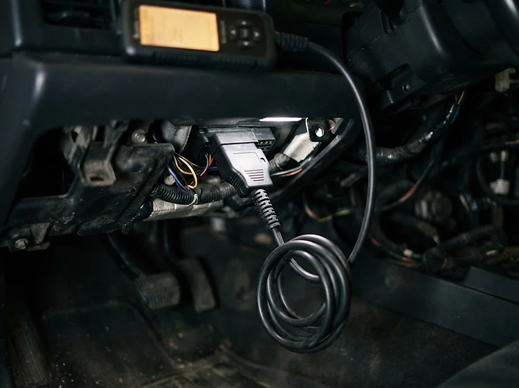 OBD2 diagnostic scanner connected to a vehicle diagnostic port in Blackburn