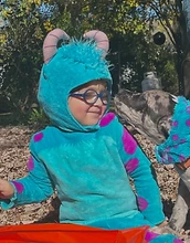 Child and dog in matching Monsters Inc costumes
