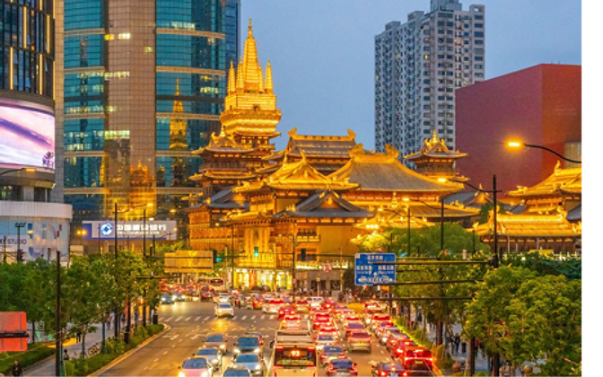 Jing'an Temple — a gilded pagoda framed by glass skyscrapers