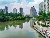 Suzhou Creek and the residential towers rising behind it.