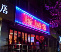 Tapthat on Wuding Road — open-window sidewalk design, 10–14 rotating taps, and a social crowd spilling onto the street.