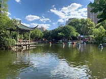 Pedal boats drifting across the lake in Lu Xun Park.