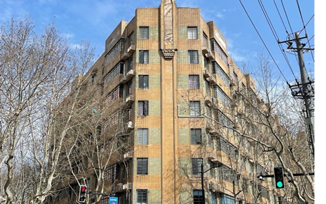 An Art Deco apartment block at a street corner — geometric façades and a tapering central tower