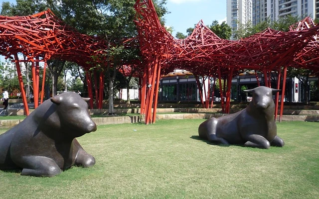 Bronze bulls and the red sculpture installation at Jing'an Sculpture Park