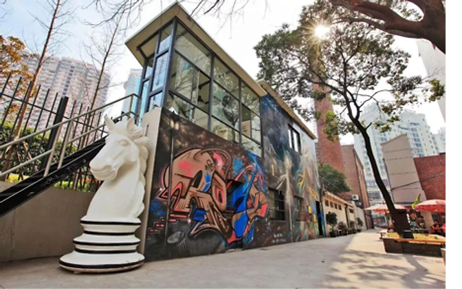 Street art in a Shanghai alley — a graffiti wall and a giant chess knight