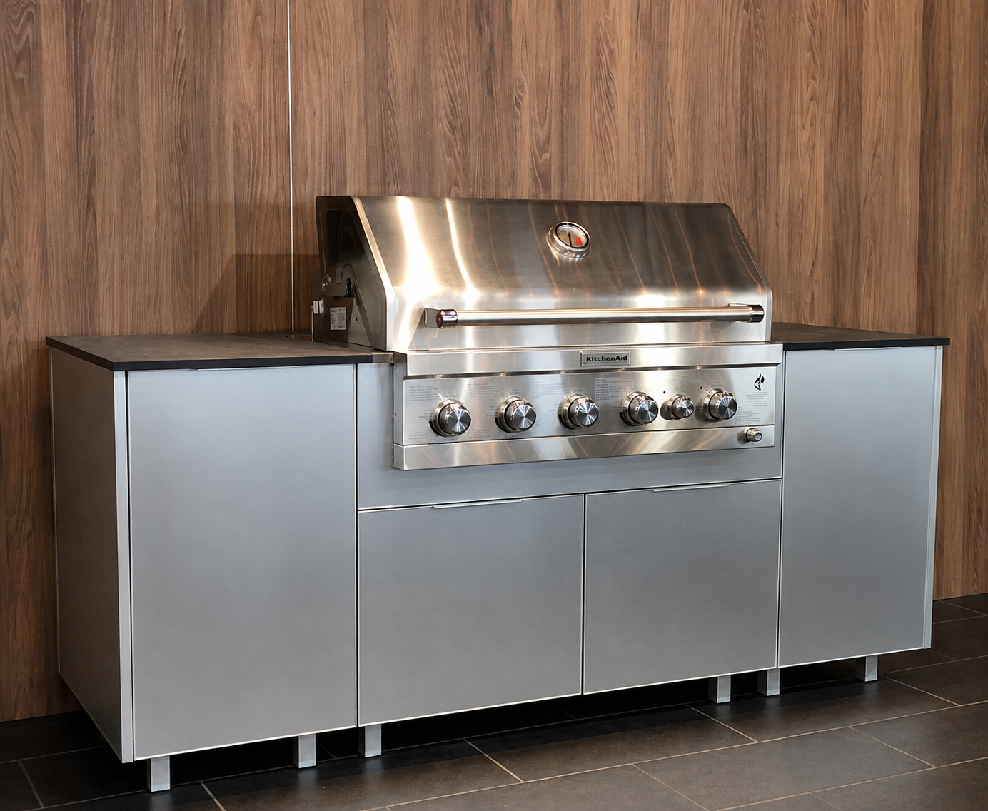 Outdoor kitchen — brushed silver BBQ against woodgrain wall