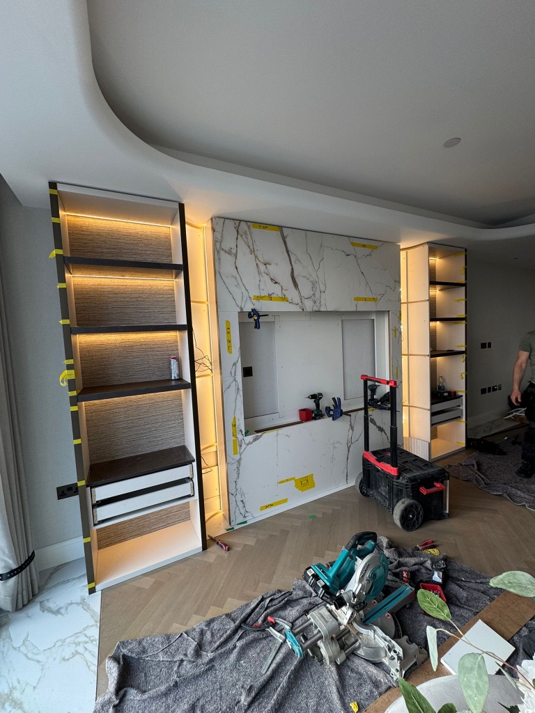 Installation in progress — Marble media wall being fitted