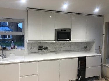 Kitchen near completion — marble-effect splashback
