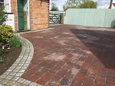 Block-paved driveway with cobble edging & five-bar gate