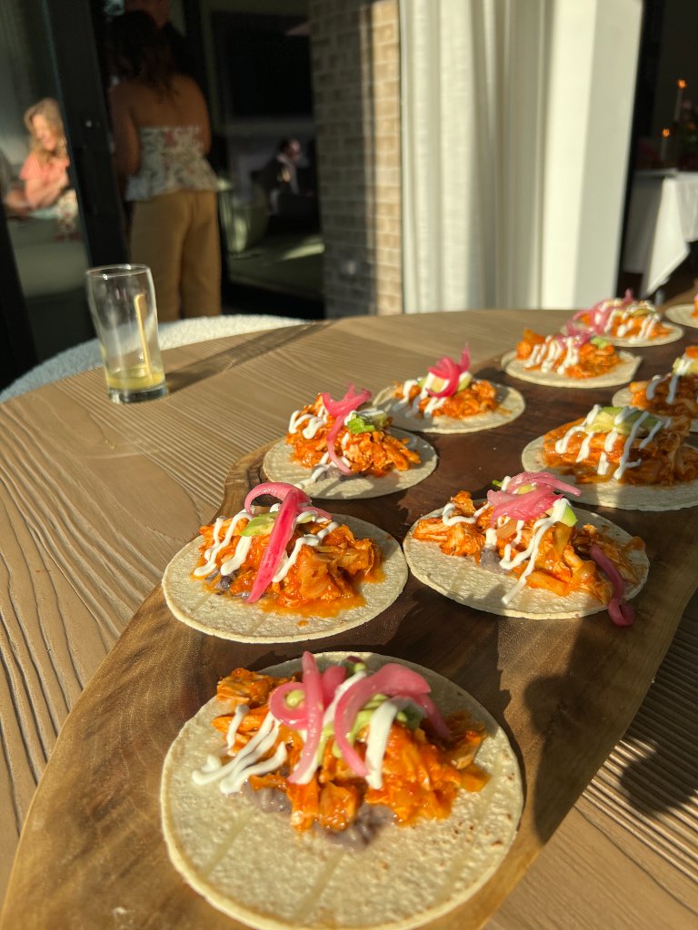Shredded chicken tacos with avocado, crema and pickled onions