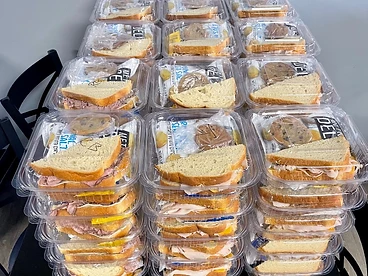 Individual catering boxes with sandwich, chips, and cookie