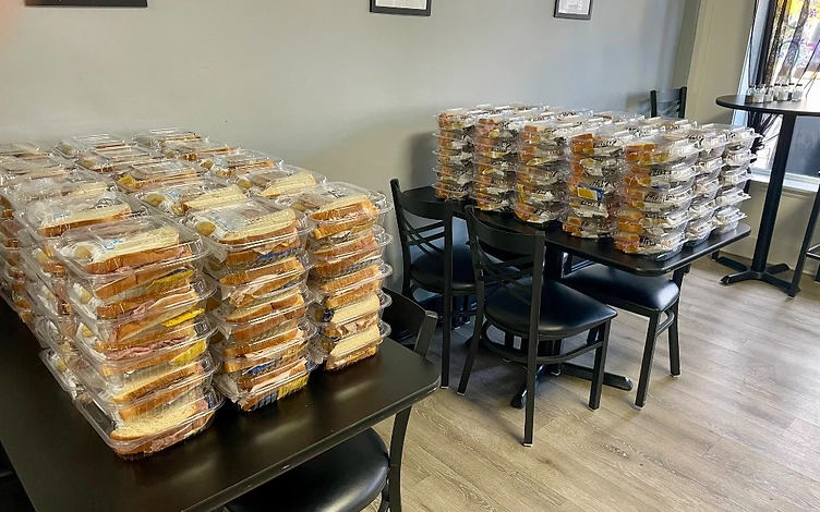 Catering box lunches stacked on a table