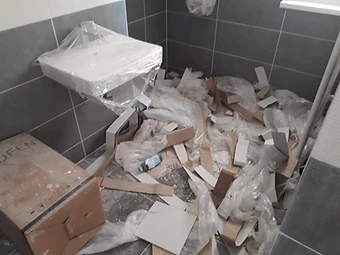 Odpadki in embalaža po prenovi kopalnice, pripravljeni za iznos