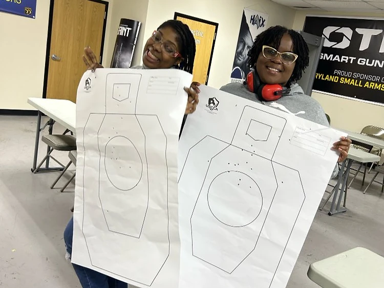 Women's training students displaying shooting targets