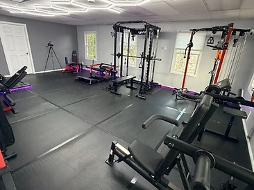 Wide view of the Armed & Trained fitness studio with power rack and training equipment