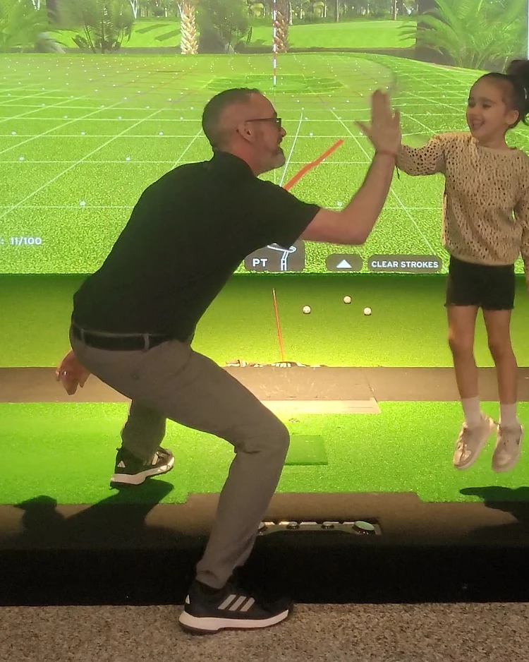 Coach Jason Cole teaching a junior student